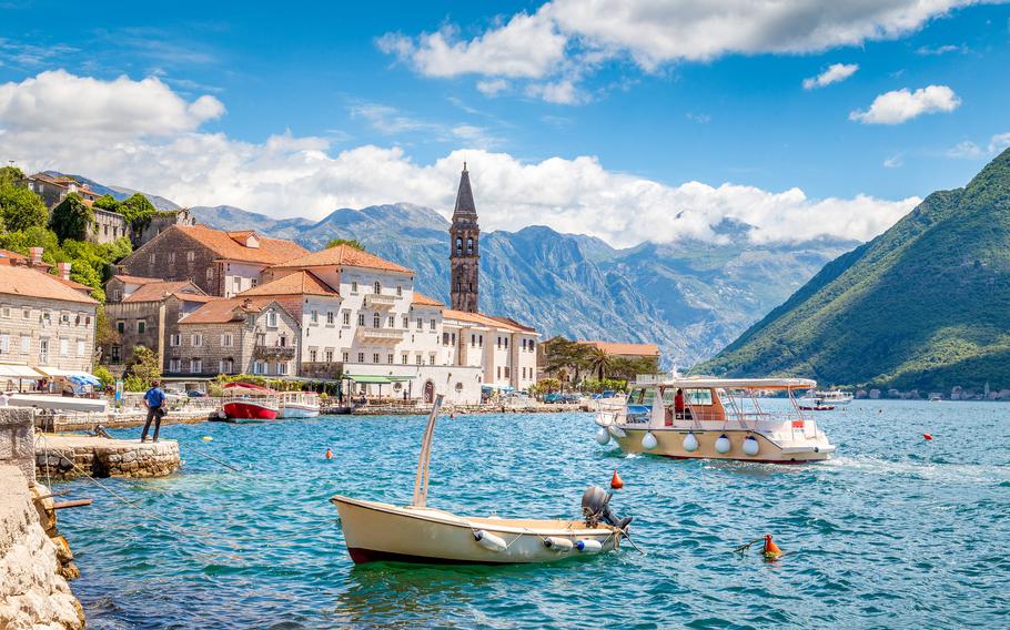 Kotor bay with boats and mountains in Montenegro